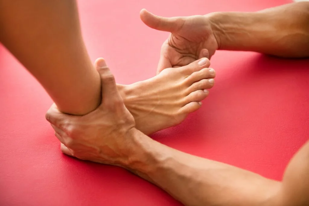 Hands examining a foot