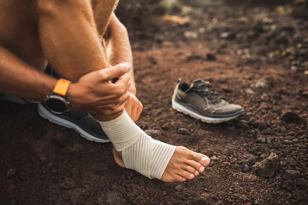 Athlete receiving assistance for ankle pain and instability on the field